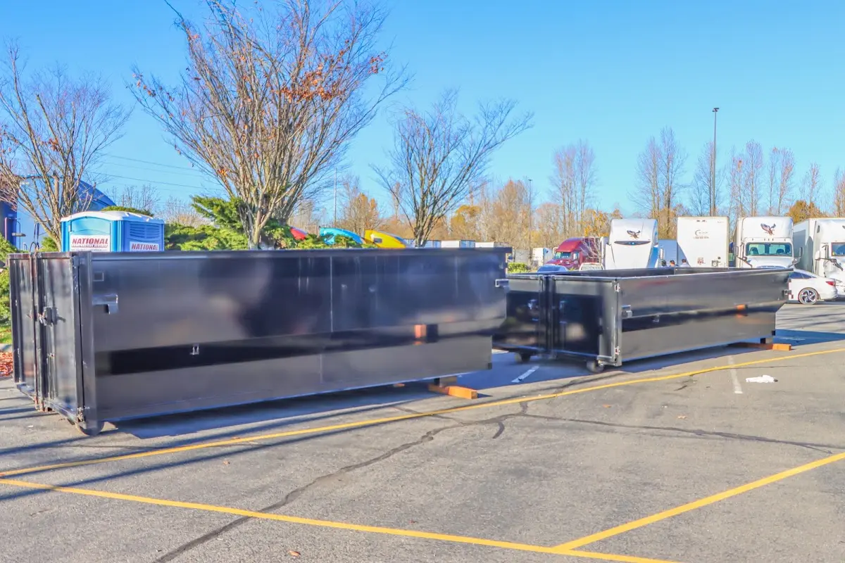 Professional dumpster rental service with roll-off container on residential driveway in Kent